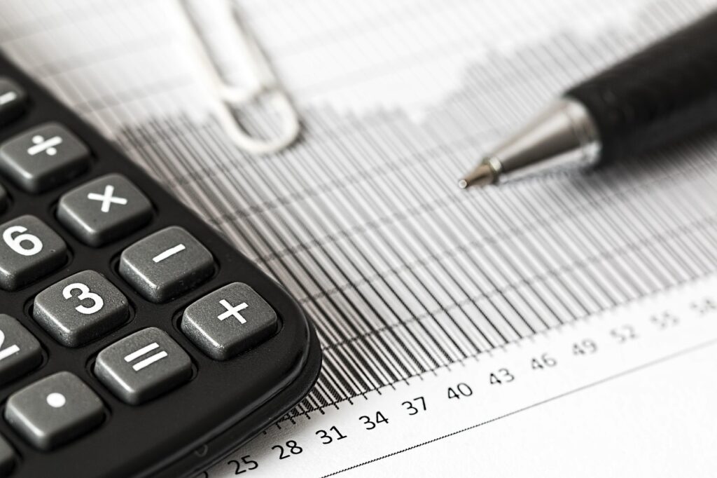 document with calculator and pen - underinsurance